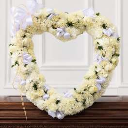 Heart-shaped white floral wreath with lavender ribbons