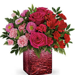 Pink and red mixed bouquet in a red square vase