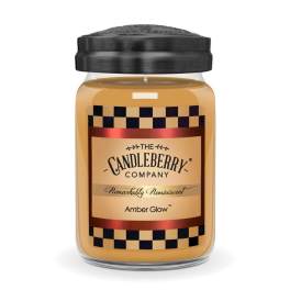 Amber candle in a glass jar with a black lid
