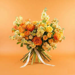 Orange and yellow rose bouquet tied with a white ribbon