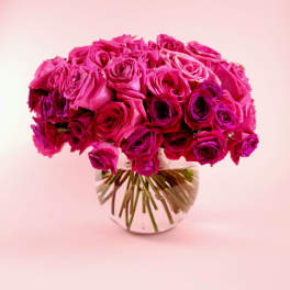 Bouquet of bright pink roses in a clear glass vase