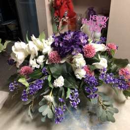Large purple, white, and pink floral arrangement with a Happy Mother's Day sign