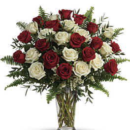 Bouquet of red and white roses in a clear glass vase