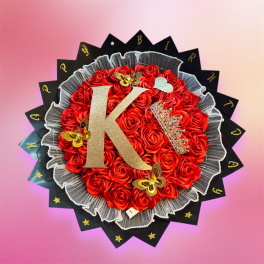 Red rose bouquet with a gold letter K and butterfly decorations