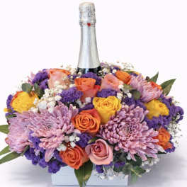 Mixed bouquet with roses and purple chrysanthemums around a champagne bottle