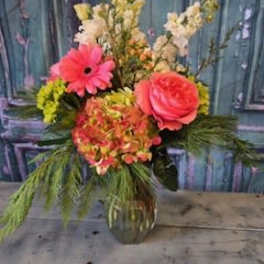 Pink gerbera and rose arrangement in a glass vase