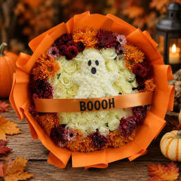 Halloween bouquet with a ghost made of white flowers and orange wrap