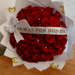 A bouquet red roses. Wrapped in designer paper