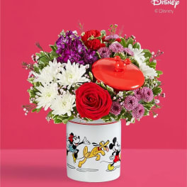 Bouquet of red, white, and purple flowers in a Disney Mickey and Friends container