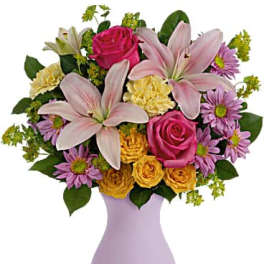 Pink roses and lilies in a lavender vase