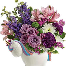 Bouquet in a unicorn-shaped ceramic container with purple, pink, and white flowers