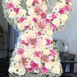 Large floral arrangement shaped like the number 50 with pink and white roses and lilies