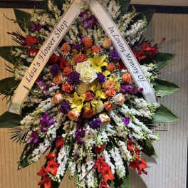 Large standing sympathy wreath with mixed roses and orchids on a ribboned easel