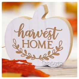 White pumpkin-shaped sign reading "harvest HOME"