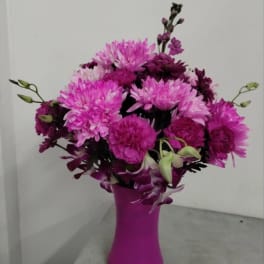 Pink and purple bouquet in a magenta vase