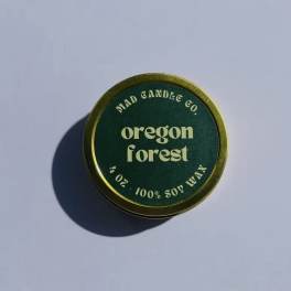Round green candle tin labeled Oregon Forest
