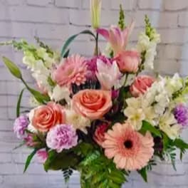Pink and white mixed flower arrangement in a glass vase