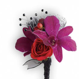 Red rose boutonniere with purple orchid petals and black accents