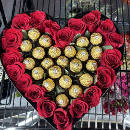 Heart-shaped box of red roses and gold-wrapped chocolates