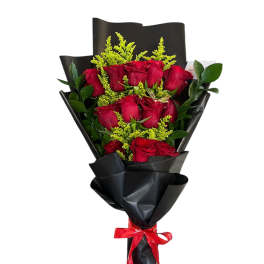 Bouquet of red roses wrapped in black paper with a red ribbon