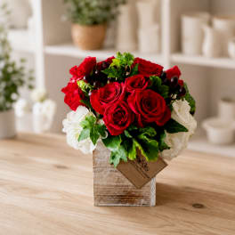 Red roses and white hydrangeas in a square wrapped vase