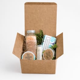 Gift box with bath salts, balm, and other self-care items