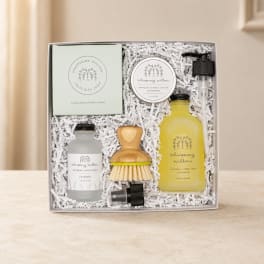 Lavender-themed gift set in a box with soap, salve, spray, soap dispenser, and brush