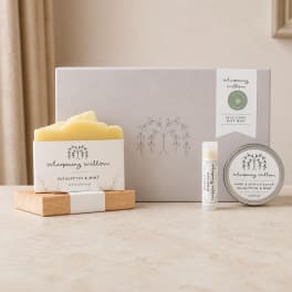 Self-care gift box with a candle, lip balm, and hand salve