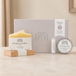 Lavender self-care gift box with a candle, balm, and lip product