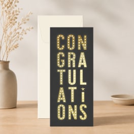 Congratulations card standing in front of an envelope on a tabletop
