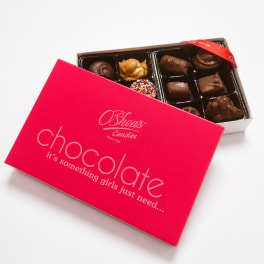 Box of assorted chocolates with a bright pink lid