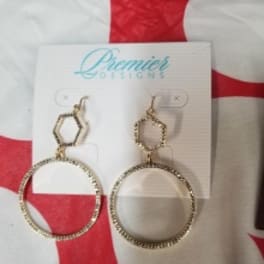 Pair of gold-tone hoop earrings on a display card
