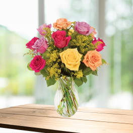 Mixed roses in a clear glass vase