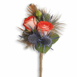 Small bouquet with coral roses and blue thistle on a wrapped handle