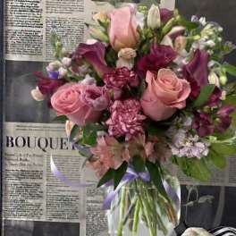 Pink and purple mixed bouquet in a clear glass vase