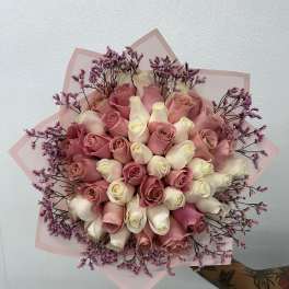 Bouquet of pink and white roses with purple filler flowers