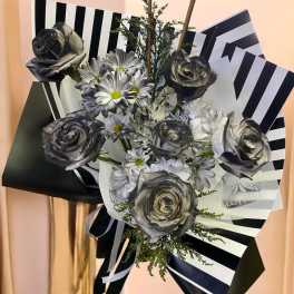 Bouquet of silver-gray roses and white daisies with black-and-white wrapping