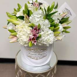 White hydrangea and lily bouquet in a white wrap