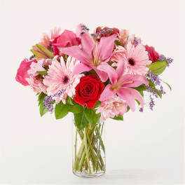 Pink mixed flower bouquet in a clear glass vase