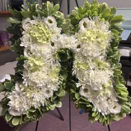 White floral letter arrangement with green variegated foliage