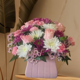Pink and white mixed bouquet in a lavender vase