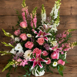 Pink and white mixed flower arrangement in a white vase