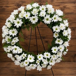 White daisy wreath on a black stand