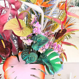 Tropical arrangement with orchids and colorful anthuriums