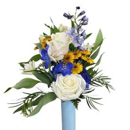 White roses and blue flowers arranged in a tall light blue vase