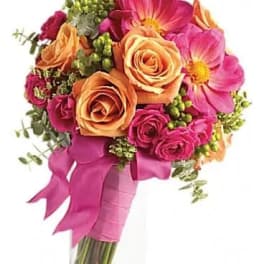 Bouquet of pink and peach roses with pink cosmos in a glass vase