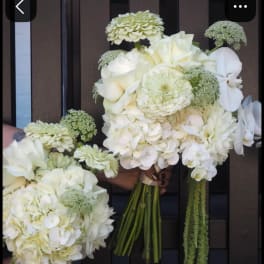 White wedding bouquets with roses, hydrangeas, and orchids