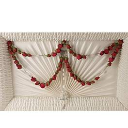 White casket with red rose garland