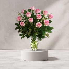 Pink roses arranged in a clear glass vase