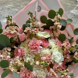 Pink and white bouquet with carnations and roses wrapped in pink paper